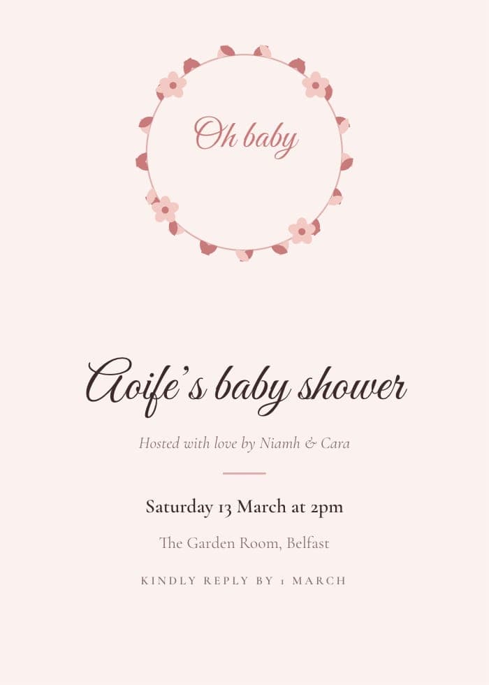 Wildflower baby shower invitation with a wreath of pink flowers